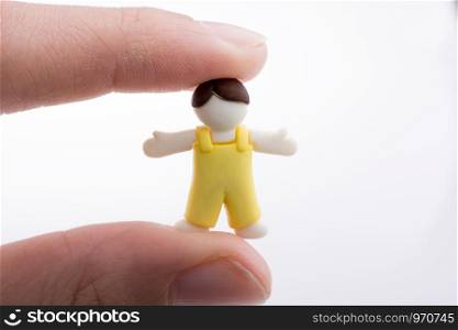 Hand holding a child figure on a white background