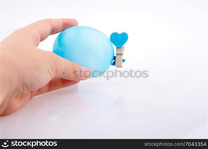 Hand holding a Colorful small balloon on a white background