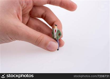 Hand holding a figure on a white background