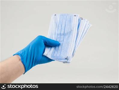 Hand holding a medical protective mask on a white background. Coronavirus Protection Concept. medical cotton mask