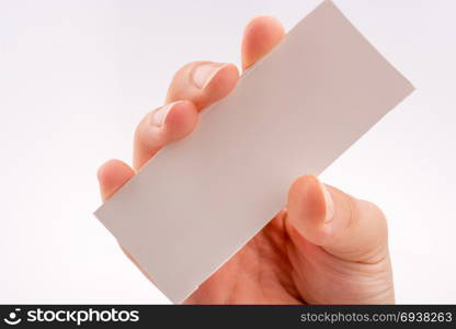Hand holding a note paper on a white background