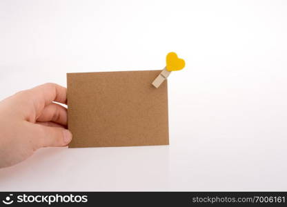 Hand holding a paper with a clip on it