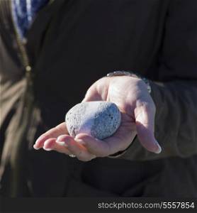 Hand holding a pebble, Twillingate, North Twillingate Island, Newfoundland And Labrador, Canada