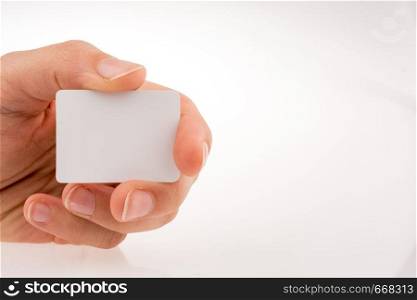 Hand holding a piece of paper on a white background
