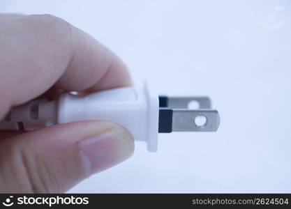 hand holding a plug