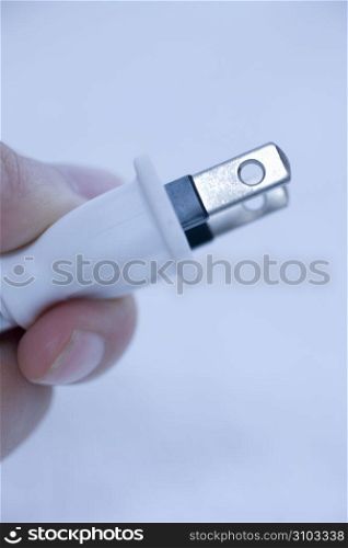 hand holding a plug
