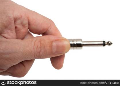 Hand holding a plug from a microphone
