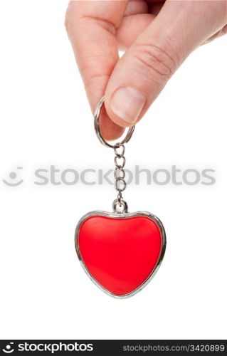 Hand holding a red heart on a chain