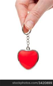 Hand holding a red heart on a chain