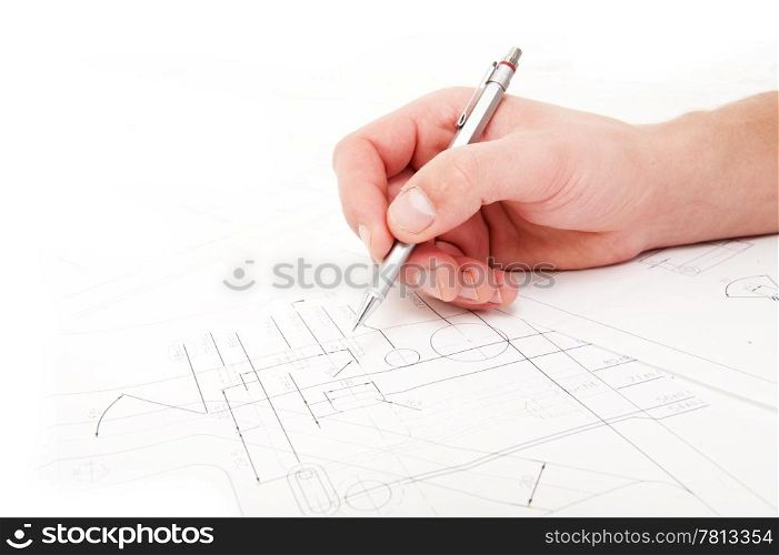 Hand, holding a refillable pencil, checing the measurements and tolerances on a technical drawing