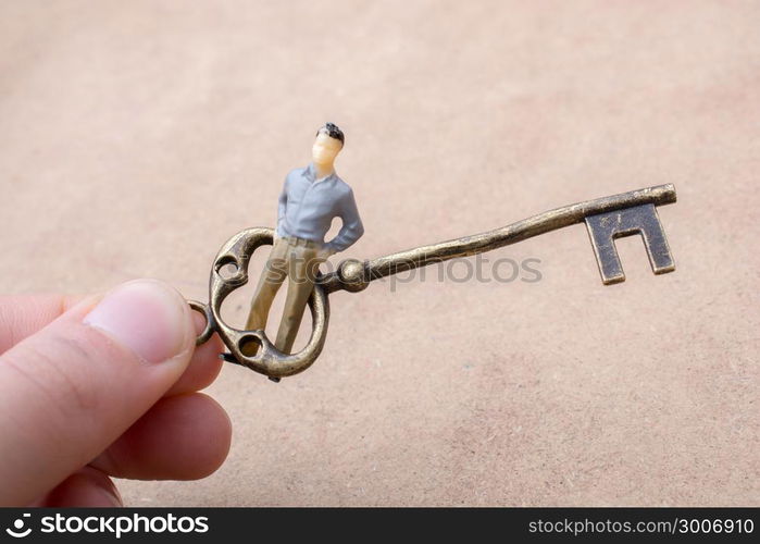 Hand holding a retro styled golden color decorative key