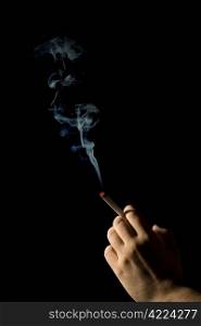 hand holding a smoking cigarette isolated