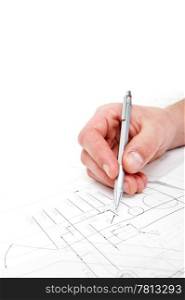 Hand, holding a steel refillable pencil, checking the measurements on a technical drawing