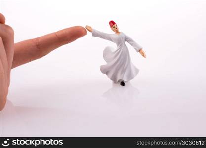 Hand holding a Sufi DerviAY. Hand holding a Sufi DerviAY on a white background
