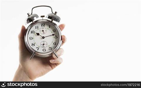 hand holding alarm clock with copy space. High resolution photo. hand holding alarm clock with copy space. High quality photo