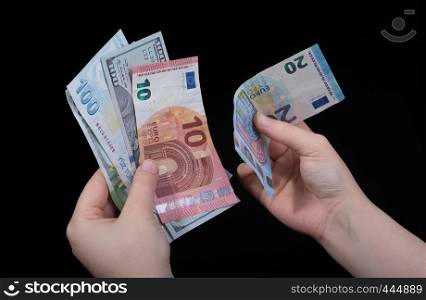Hand holding American dollar banknotes isolated on black background