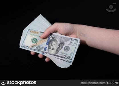 Hand holding American dollar banknotes isolated on white background