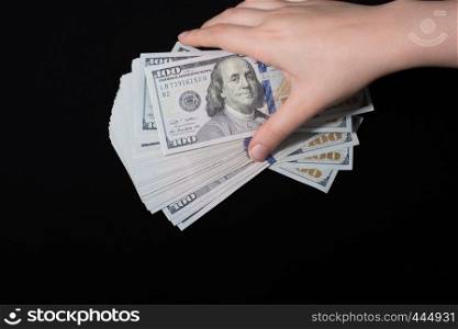Hand holding American dollar banknotes isolated on white background