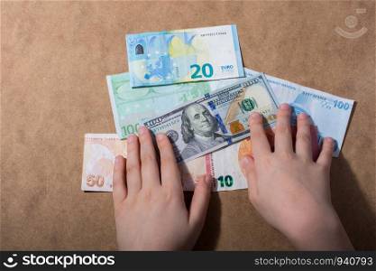 Hand holding American dollar banknotes isolated on wooden background