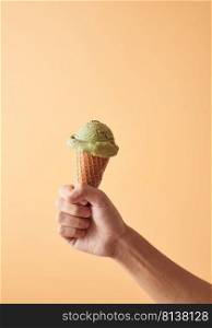 Hand holding an ice cream cone of green tea. . ice cream cone of green tea. 