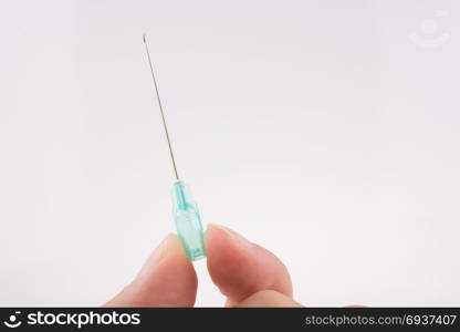 Hand holding an syringe over a white background