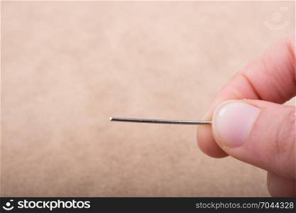 Hand holding an syringe over a white background