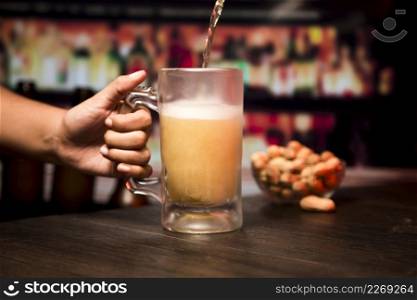 hand holding beer glass