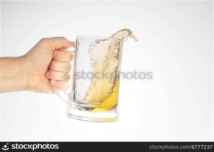 hand holding beer in glass close up