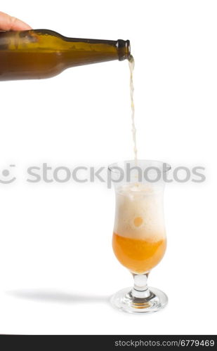 Hand holding bottle of beer and beer mug. White isolated studio shot.