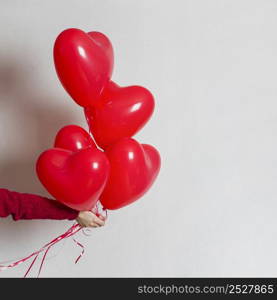 hand holding bunch balloons