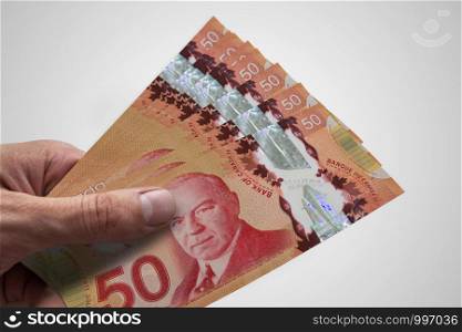 Hand holding Canadian dollars. CAD. Currency of Canada