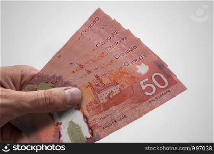 Hand holding Canadian dollars. CAD. Currency of Canada