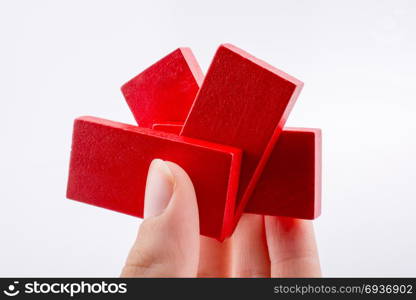 Hand holding color domino pieces in hand on a white background