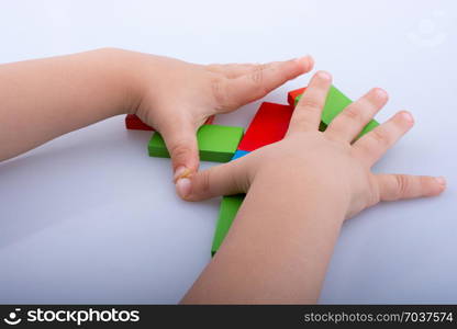 Hand holding color dominoes on a white background