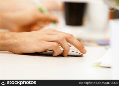 Hand holding computer mouse. Hands of office worker holding computer mouse