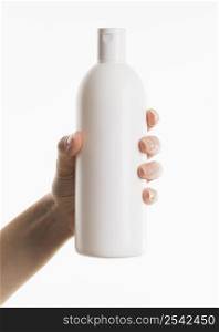 hand holding cosmetic bottle 2