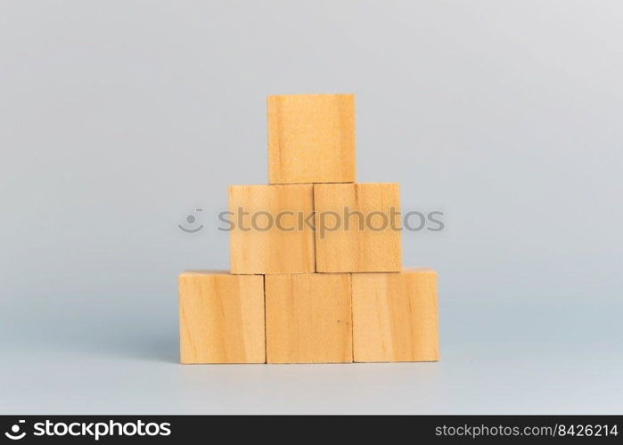 hand holding cube wood block blank on background. copy space