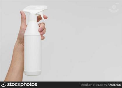 hand holding disinfectant bottle with copy space