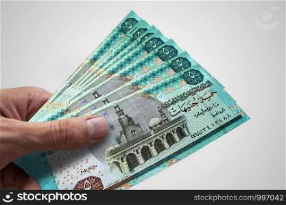 Hand holding Egyptian Pounds. EGP. Currency of Egypt.. Hand holding Egyptian Pounds. EGP. Currency of Egypt