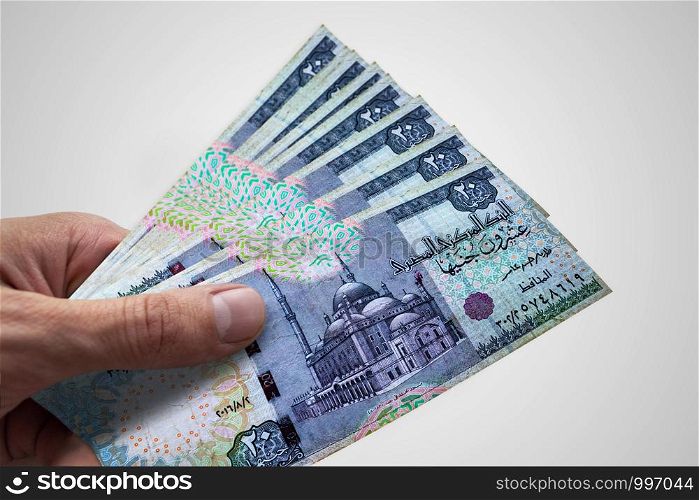 Hand holding Egyptian Pounds. EGP. Currency of Egypt.. Hand holding Egyptian Pounds. EGP. Currency of Egypt