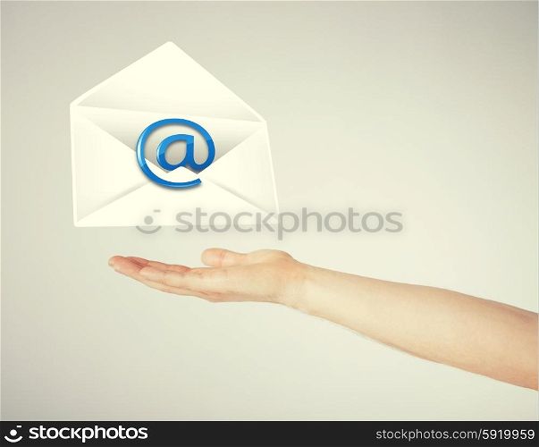 hand holding envelope with email sign. picture of hand holding envelope with email sign