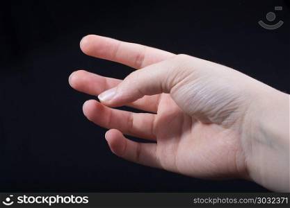 Hand holding figure. Hand threating to smash human figure on a white background