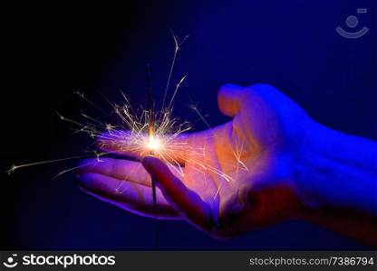Hand Holding Fire Light Sparkler in night