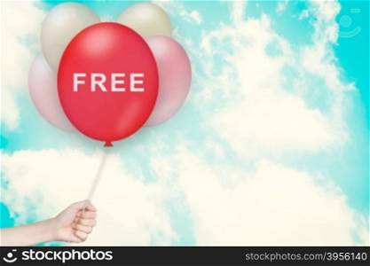 Hand Holding free Balloon with sky and vintage style