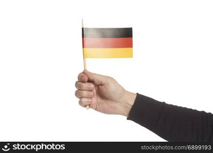 Hand holding Germany flag isolated on a white background