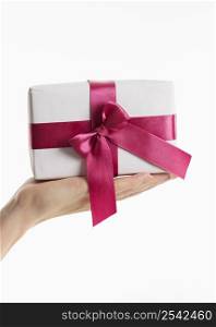 hand holding gift with bow