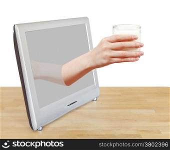 hand holding glass of milk leans out TV screen isolated on white background