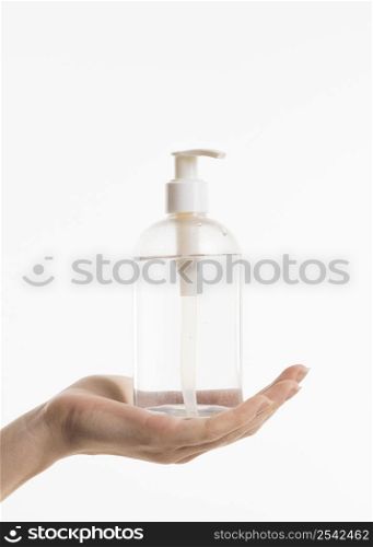 hand holding hand sanitizer bottle