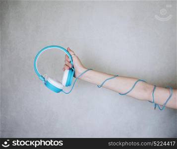Hand holding headphones