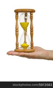 Hand holding hourglass on white
